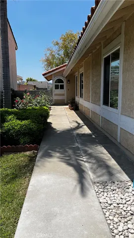 a view of a white house with a yard