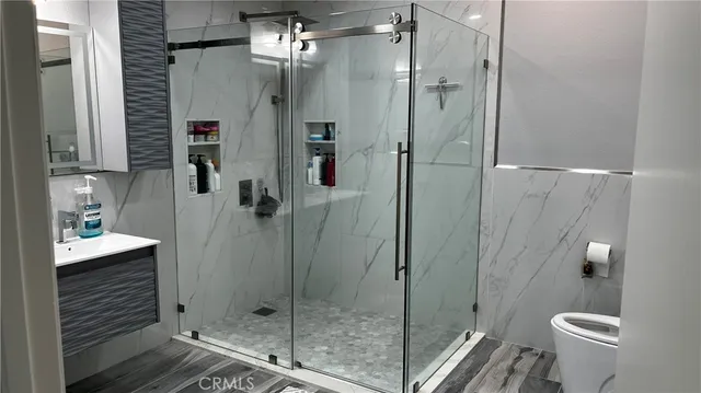 a bathroom with a shower and toilet