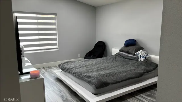 a bedroom with bed and window