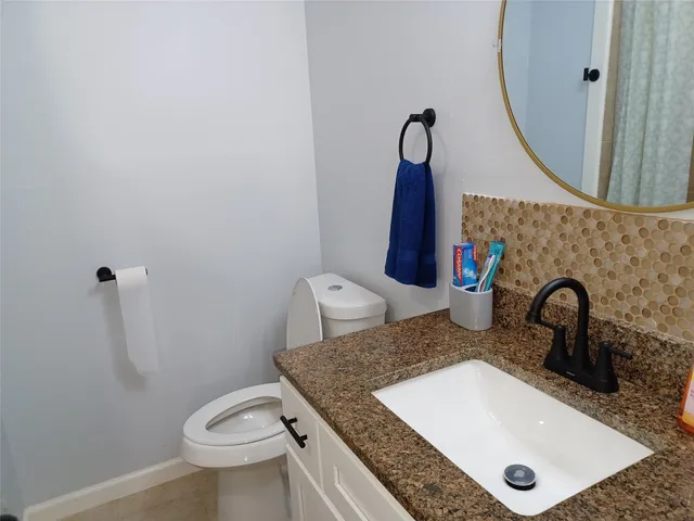 a kitchen with a sink a stove a microwave and wooden floor