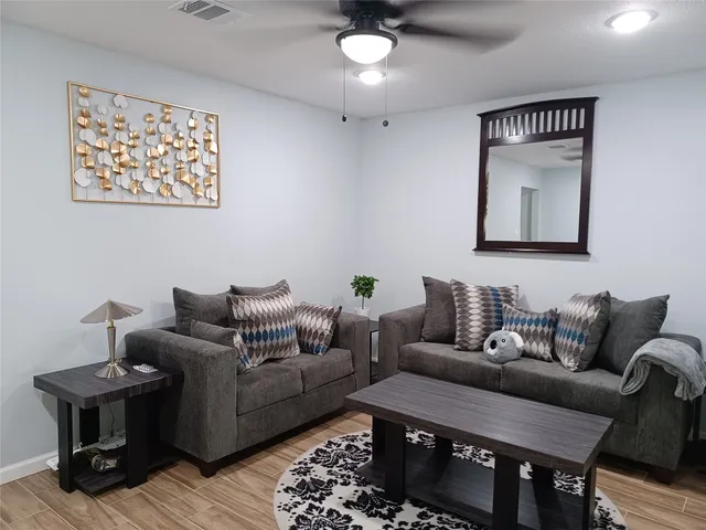 a living room with furniture and a rug