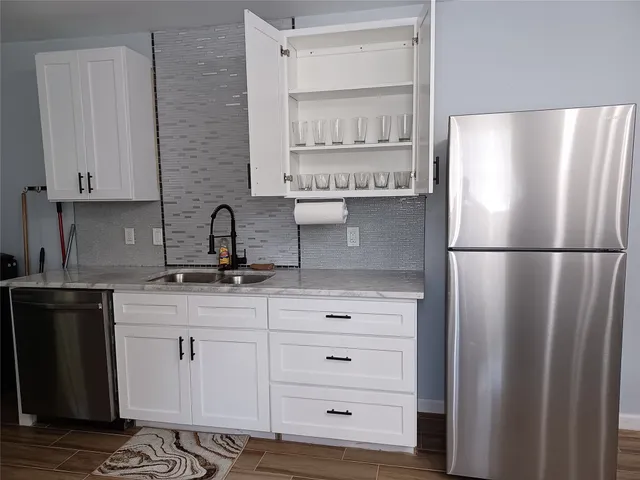 a kitchen with stainless steel appliances a refrigerator and cabinets