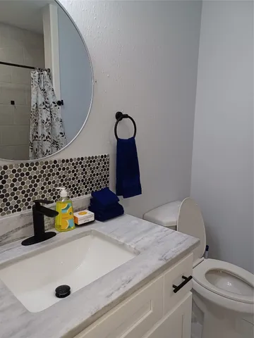 a bedroom with a bed and a television