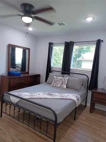 a bed sitting in a bedroom next to a window
