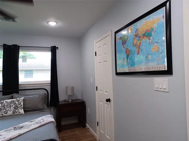 a bedroom with a bed and a mirror