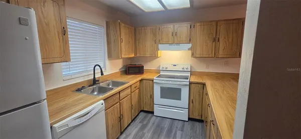 a kitchen with a sink stove and cabinets
