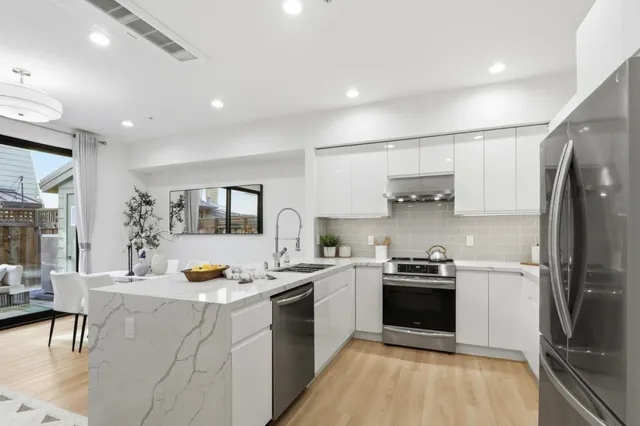 a kitchen with a sink appliances and cabinets