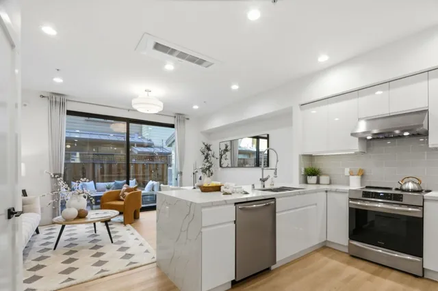 a kitchen with a sink stainless steel appliances and cabinets
