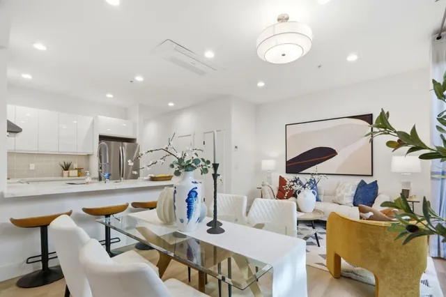 a living room with furniture a rug and white walls