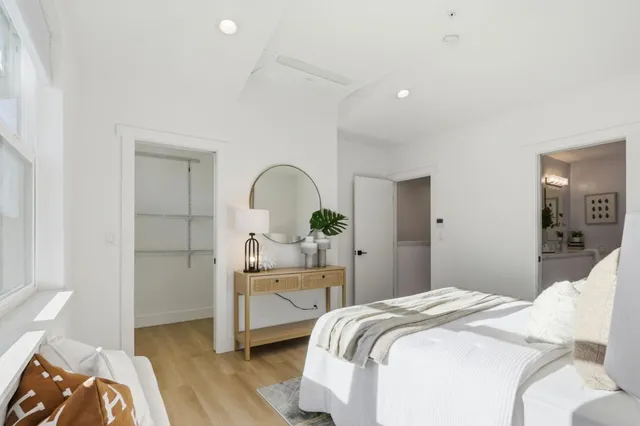 a bedroom with a bed and a mirror