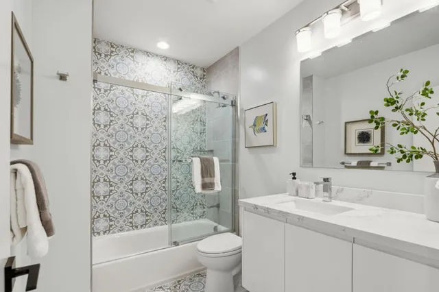 a bathroom with a sink toilet and shower