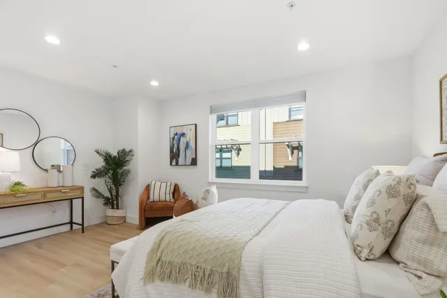 a bedroom with a bed and a large mirror