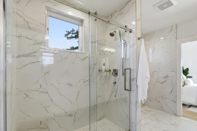 a bathroom with a shower and a sink