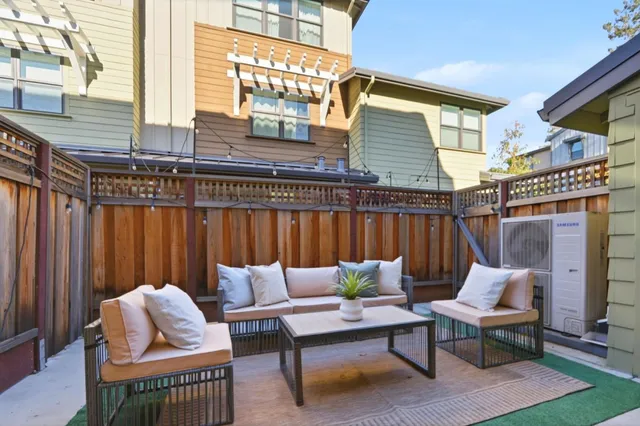 a view of a patio with a table and chairs
