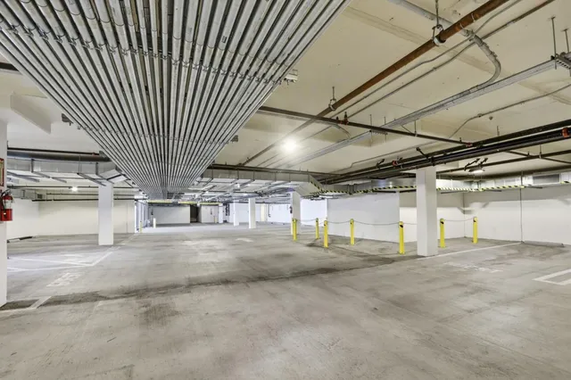 a view of a big house with a big yard and large trees
