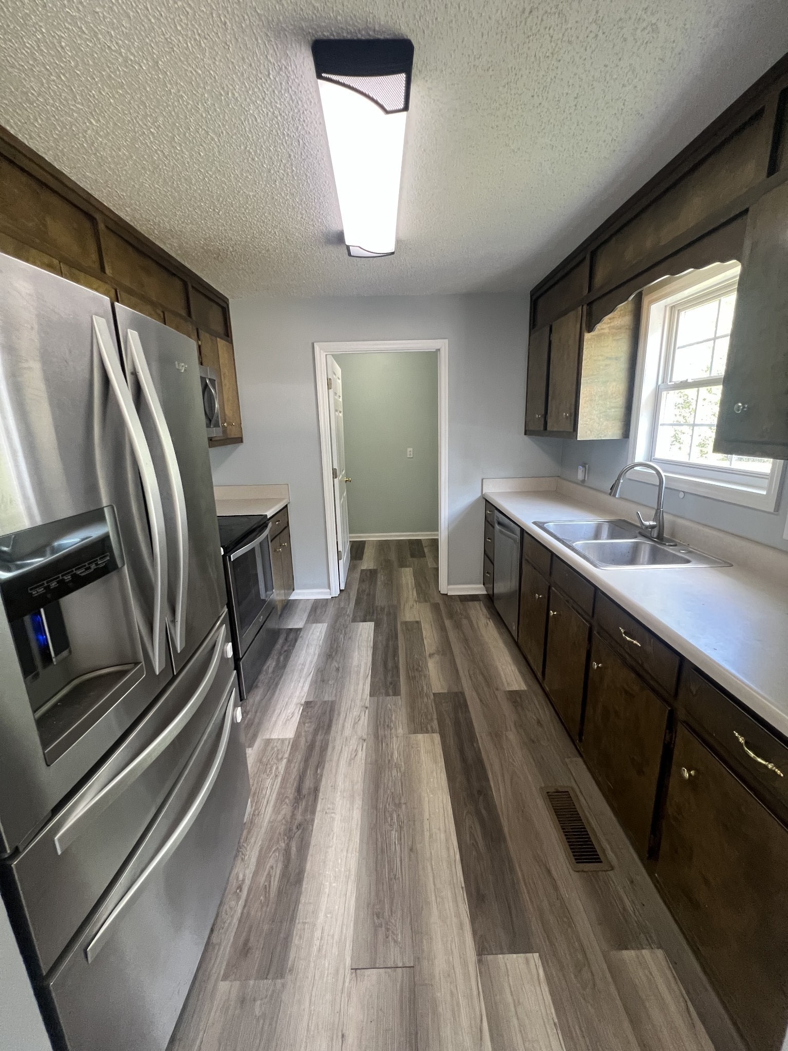 149 Hawthorne Street Pulaski, TN 38478 - Photo 8 of 33 a view of a kitchen with a sink and wooden floor