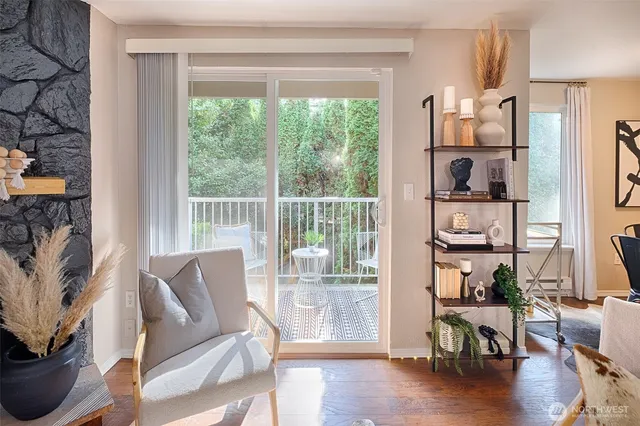 a living room with furniture and a floor to ceiling window