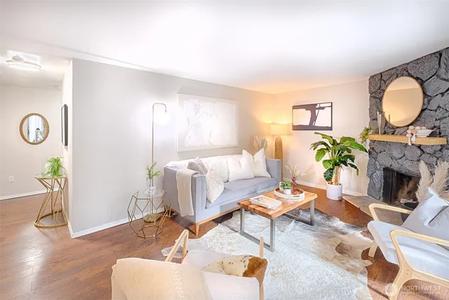 a living room with furniture a fireplace and a window