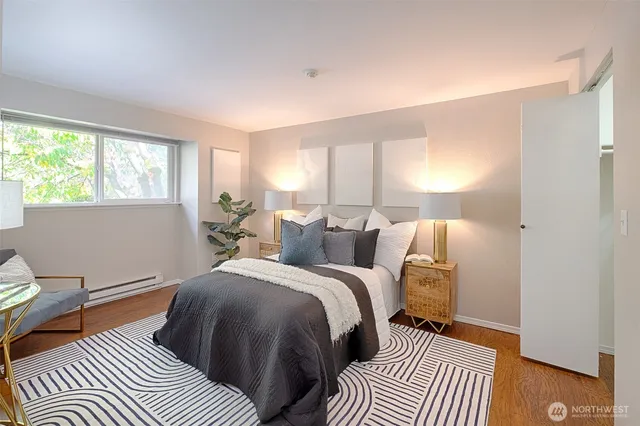 a bedroom with a bed and wooden floor