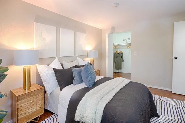 a bedroom with a bed and wooden floor