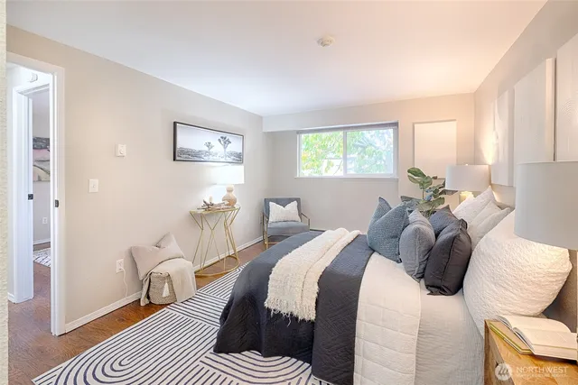 a bedroom with a bed and a large window