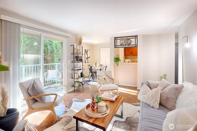 a living room with furniture and a floor to ceiling window