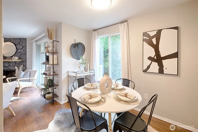a view of a dining room with furniture and a large window
