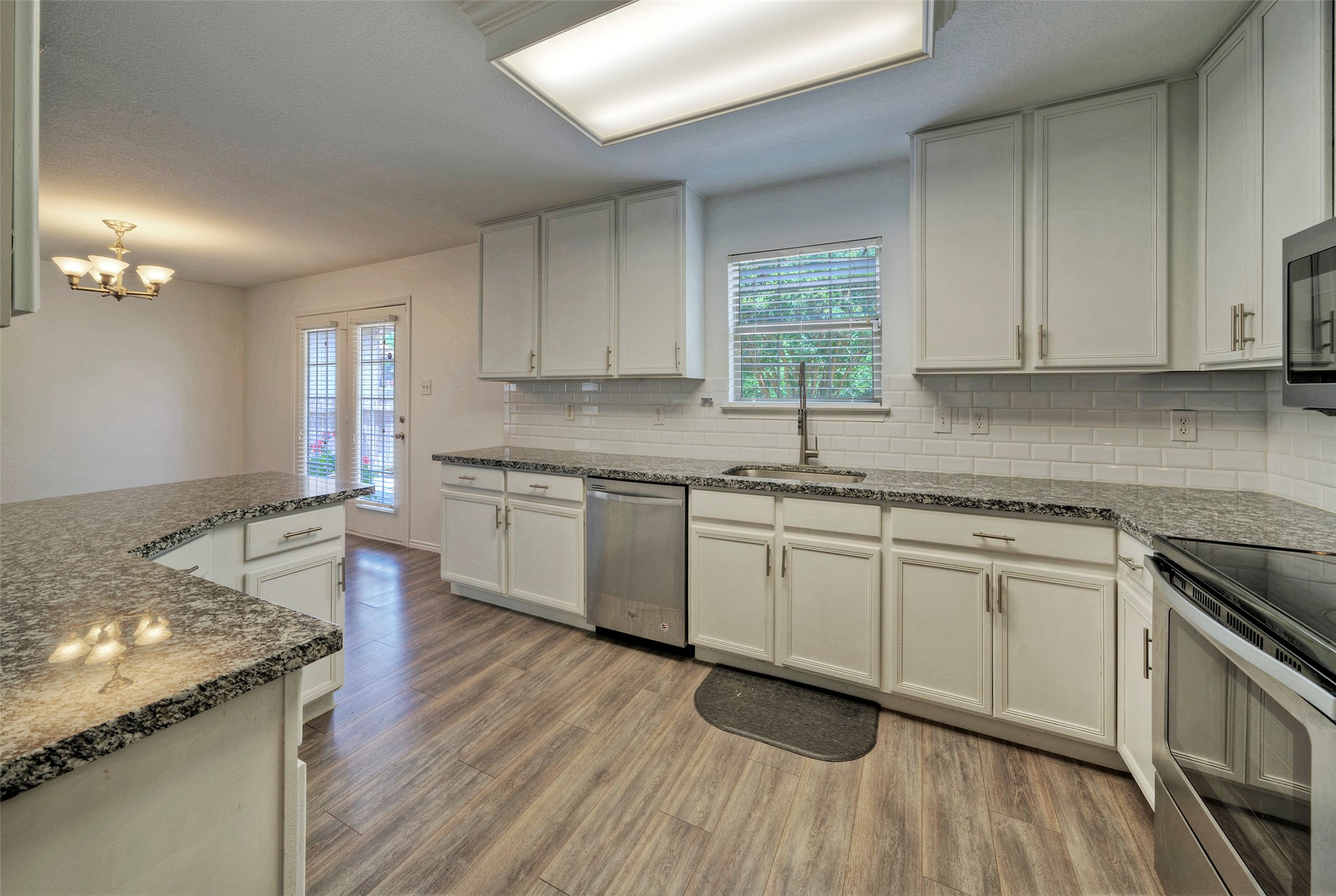 140 Plum Path Kyle, TX 78640 - Photo 1 of 22 a kitchen with granite countertop white cabinets and white appliances
