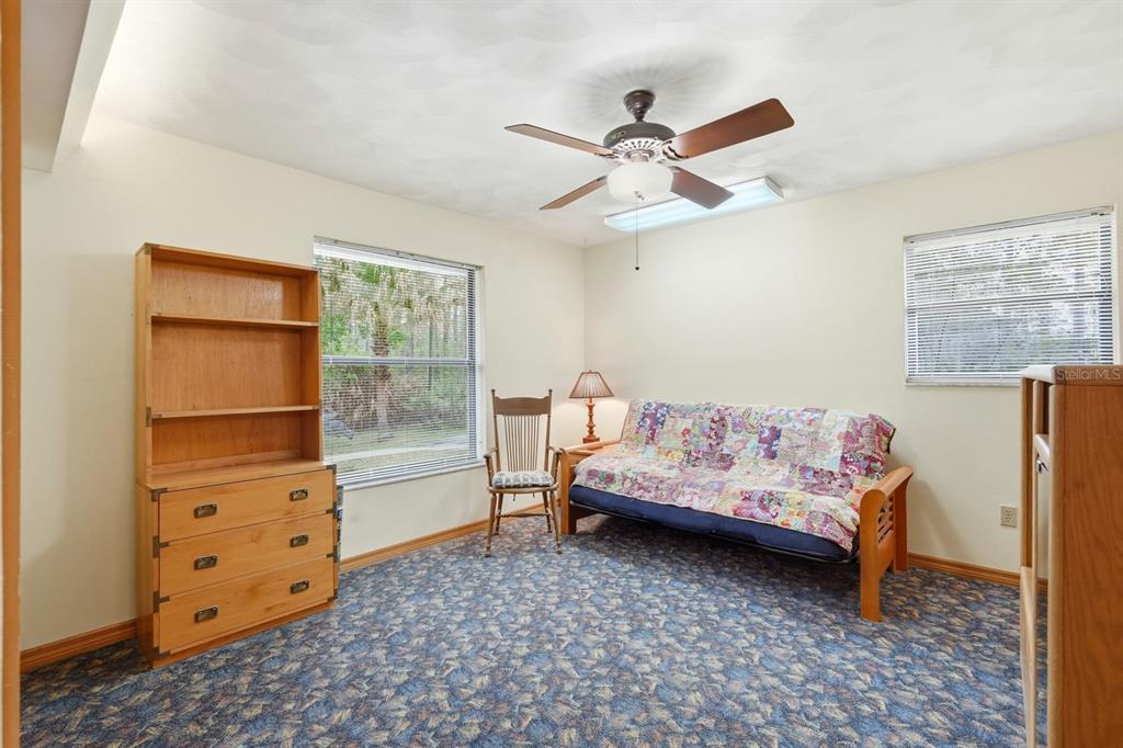 158 Cone Road Ormond Beach, FL 32174 - Photo 12 of 40 a bedroom with a bed and a cabinet