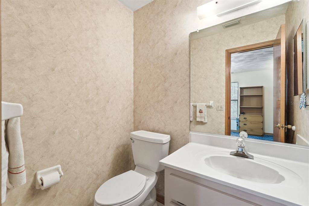 158 Cone Road Ormond Beach, FL 32174 - Photo 13 of 40 a bathroom with a toilet a sink and mirror