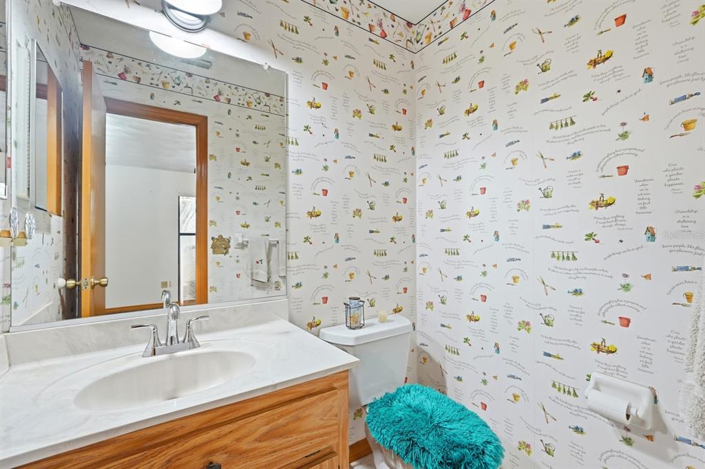 158 Cone Road Ormond Beach, FL 32174 - Photo 15 of 40 a bathroom with a sink a mirror and a shower