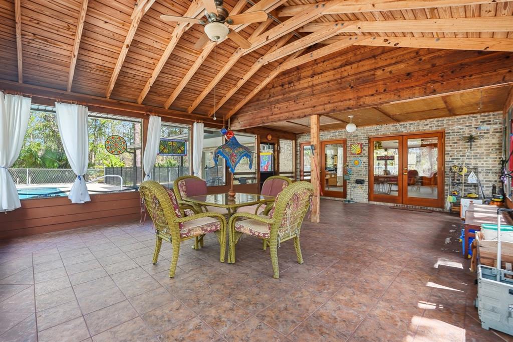 158 Cone Road Ormond Beach, FL 32174 - Photo 17 of 40 a dining room with furniture and a floor to ceiling window
