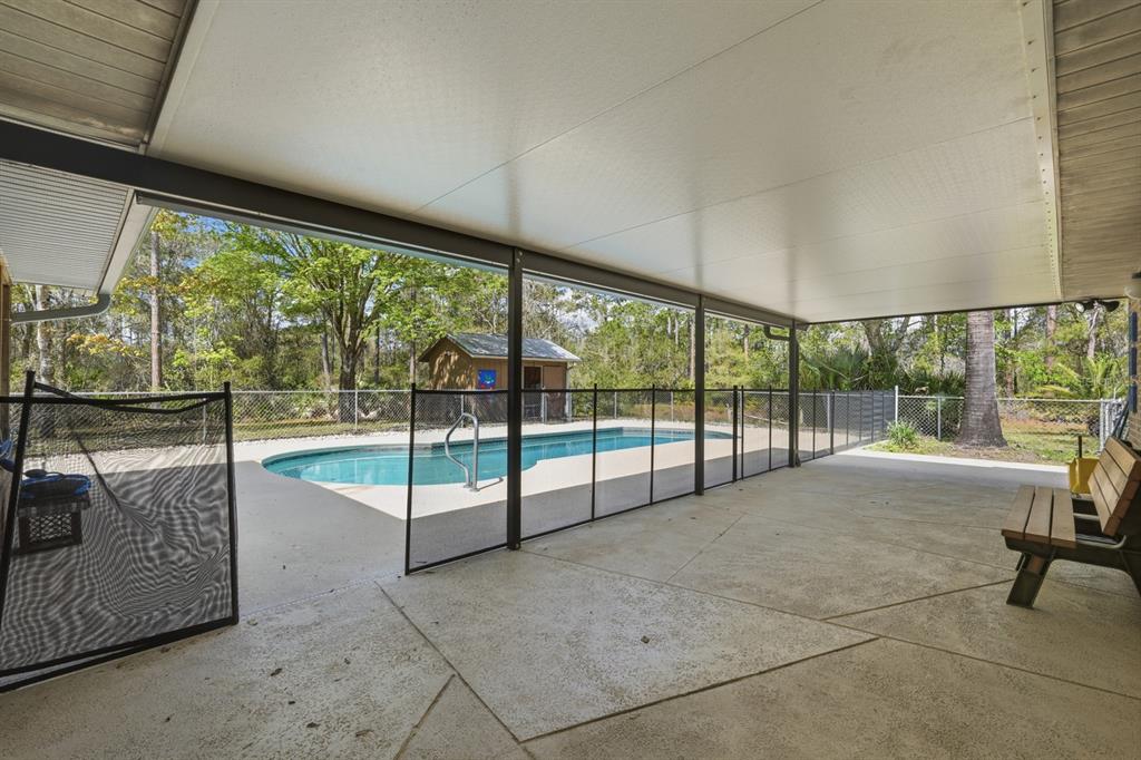 158 Cone Road Ormond Beach, FL 32174 - Photo 18 of 40 a view of an empty room with wooden floor and iron stairs