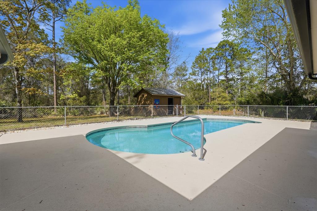 158 Cone Road Ormond Beach, FL 32174 - Photo 19 of 40 a view of a swimming pool with a yard