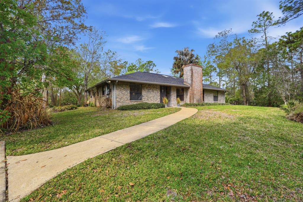 158 Cone Road Ormond Beach, FL 32174 - Photo 23 of 40 a front view of a house with garden