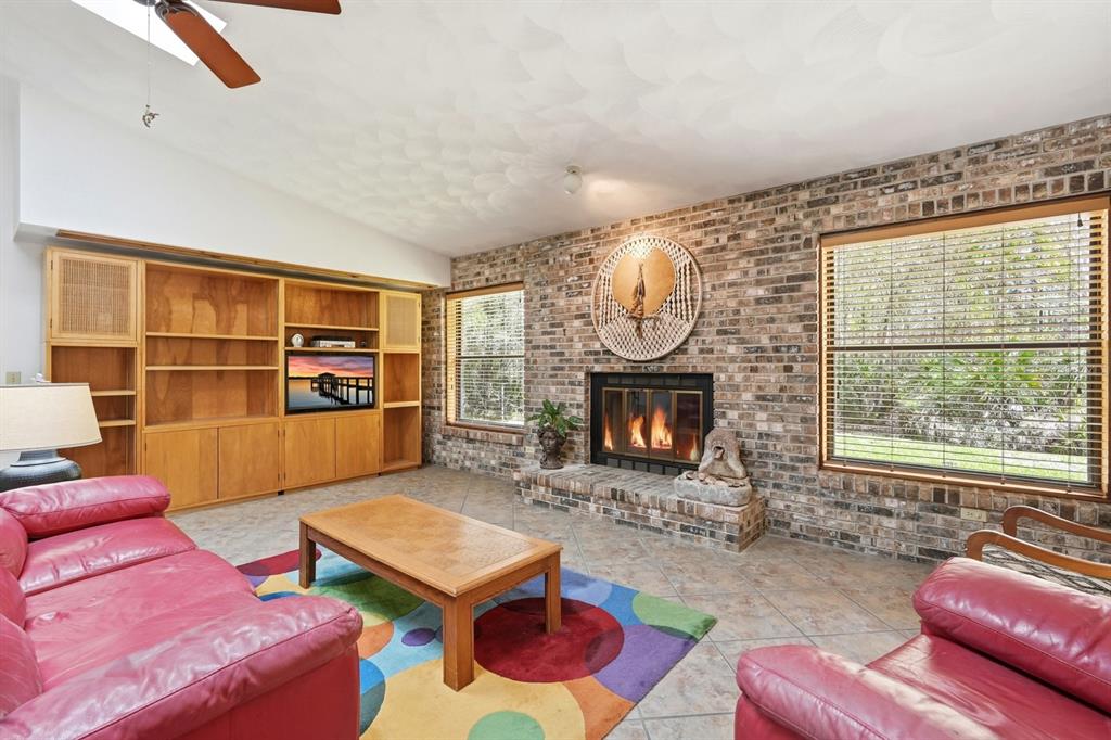 158 Cone Road Ormond Beach, FL 32174 - Photo 3 of 40 a living room with furniture and a fireplace