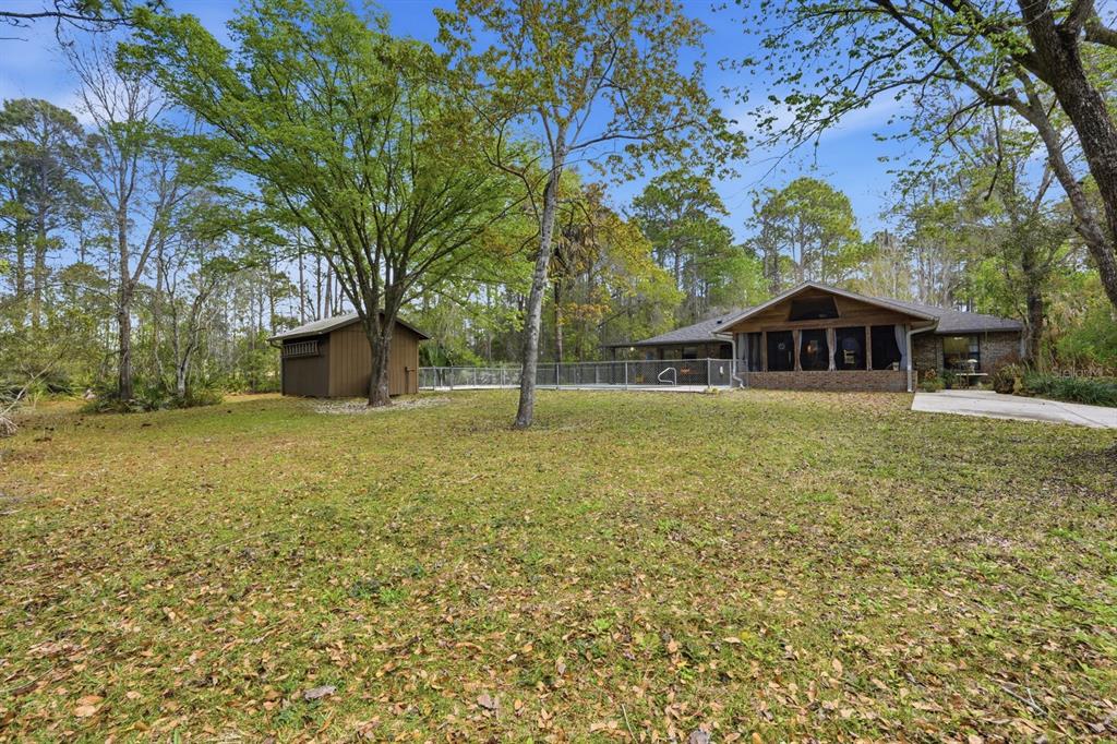 158 Cone Road Ormond Beach, FL 32174 - Photo 32 of 40 a house with swimming pool in front of it