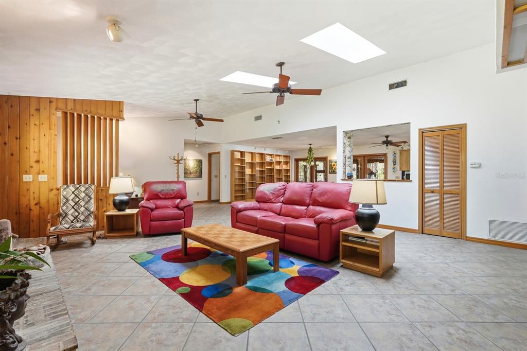 158 Cone Road Ormond Beach, FL 32174 - Photo 4 of 40 a living room with furniture a rug and gym equipment