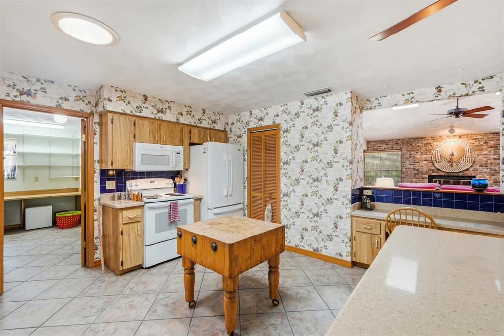158 Cone Road Ormond Beach, FL 32174 - Photo 6 of 40 a kitchen with refrigerator and cabinets