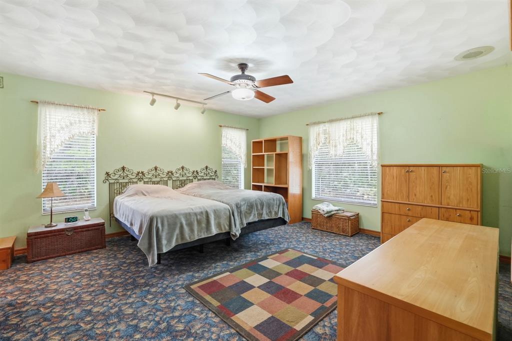 158 Cone Road Ormond Beach, FL 32174 - Photo 8 of 40 a spacious bedroom with a bed and wooden floor