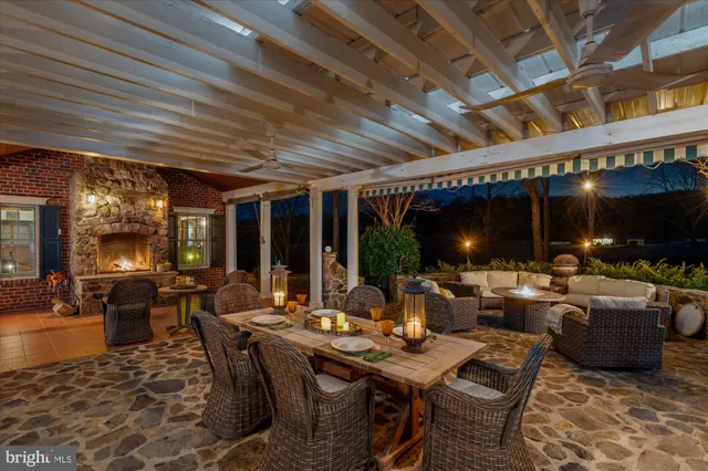 a living room with furniture a flat screen tv and a dining table