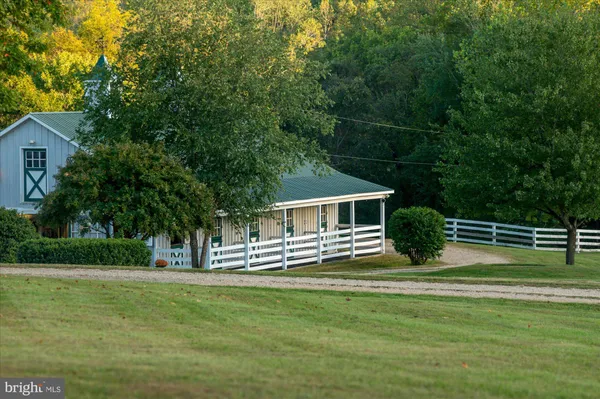 a view of house with yard and green space