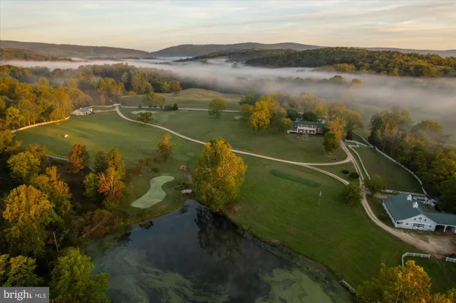 a living room with furniture a flat screen tv and paintings on the wall
