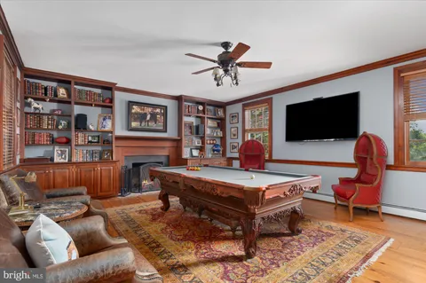 a view of a dining room with furniture a chandelier and wooden floor