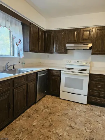 a kitchen with a sink stove and cabinets