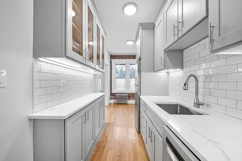 a kitchen with a sink and a refrigerator