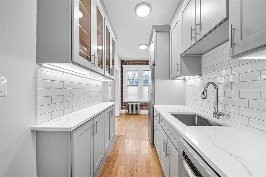 4 Crawford Street, Unit U4 Cambridge, MA 02139 - Photo 1 of 22 a kitchen with a sink and a refrigerator