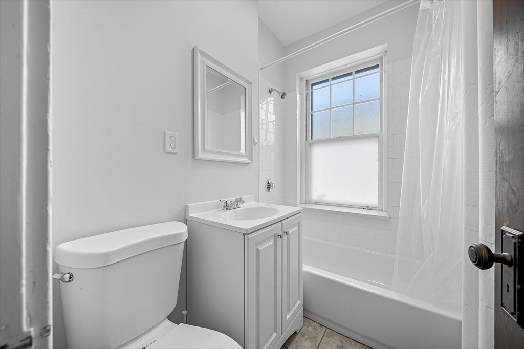 4 Crawford Street, Unit U4 Cambridge, MA 02139 - Photo 12 of 22 a bathroom with a sink a toilet and shower