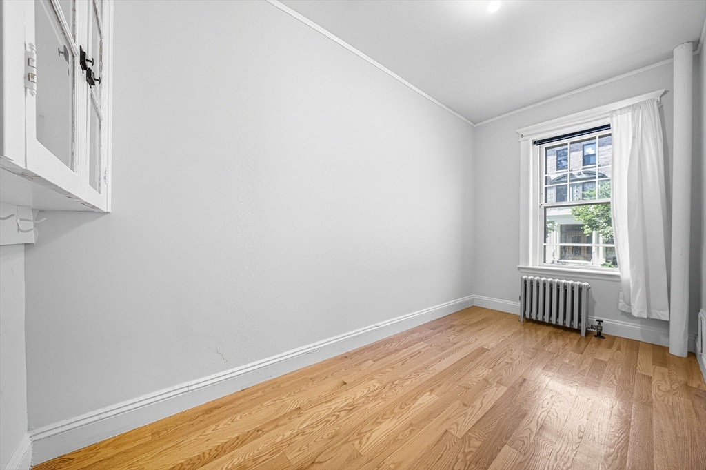 4 Crawford Street, Unit U4 Cambridge, MA 02139 - Photo 13 of 22 an empty room with wooden floor and windows