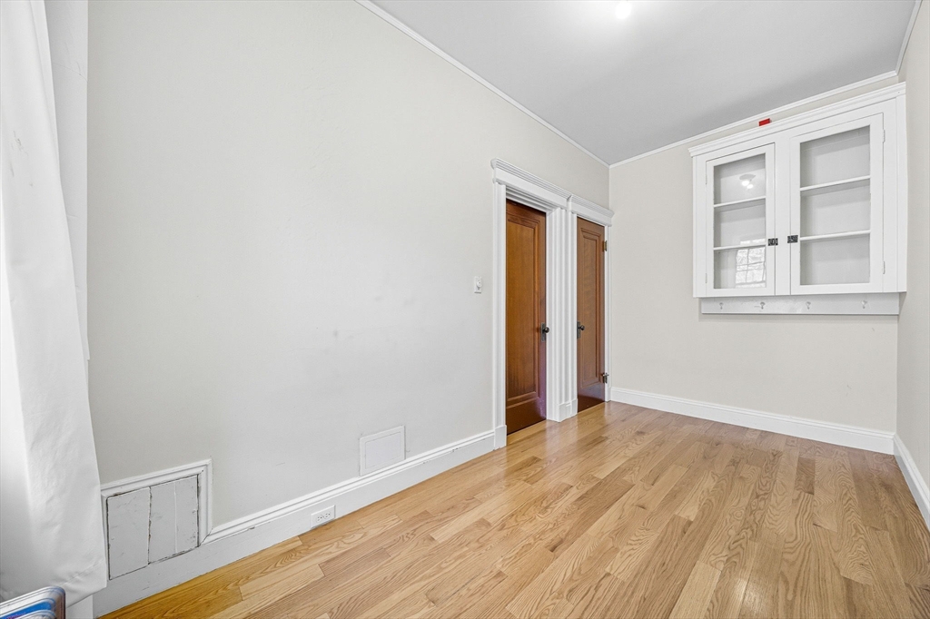4 Crawford Street, Unit U4 Cambridge, MA 02139 - Photo 14 of 22 an empty room with wooden floor and windows